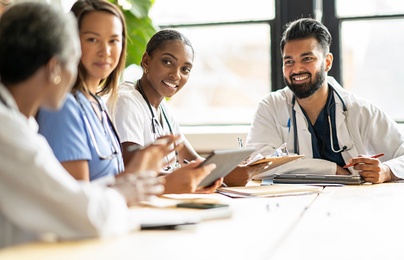 medical professionals smiling at a conference table